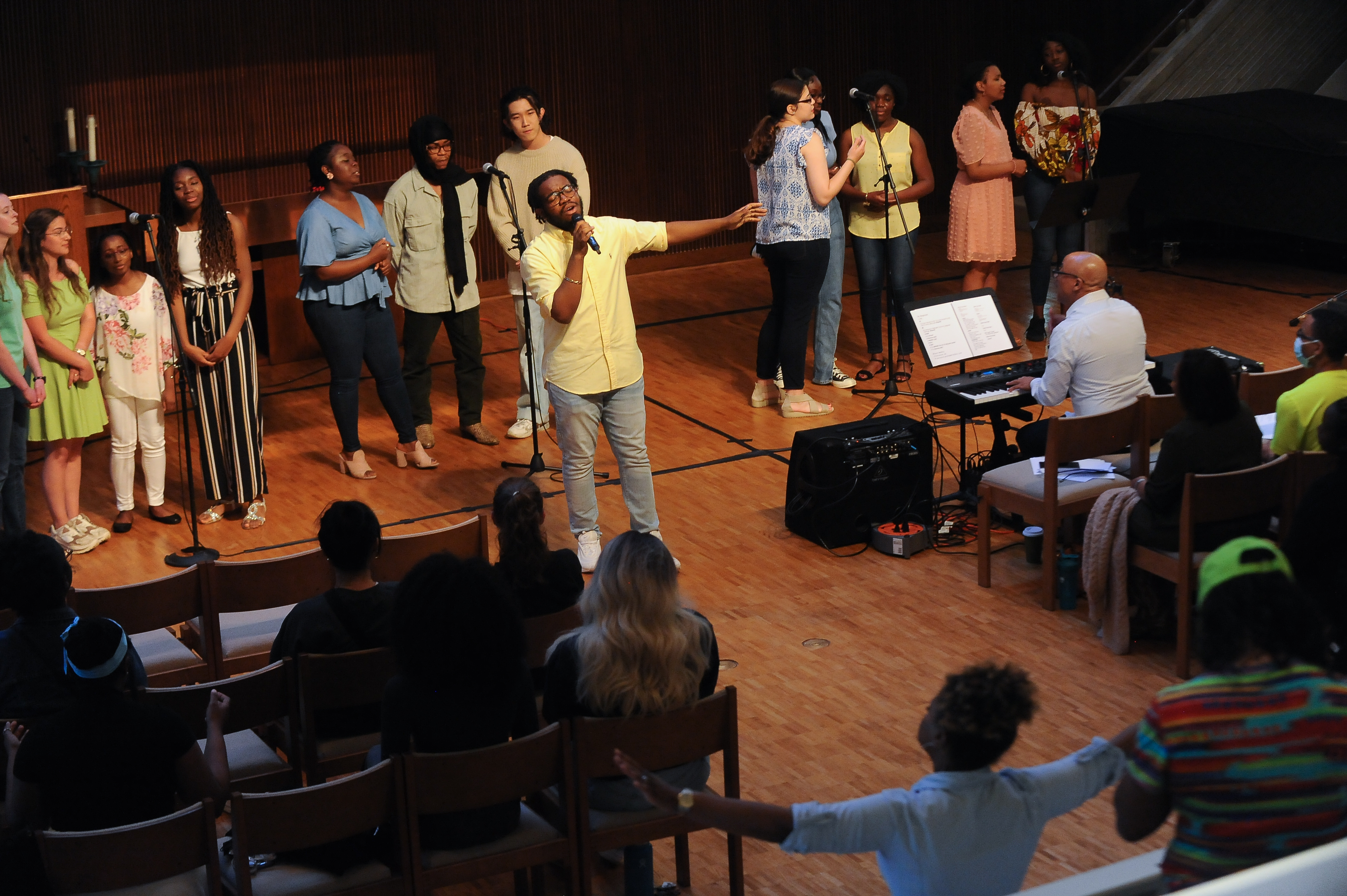 Students singing on stage during a spiritual life program