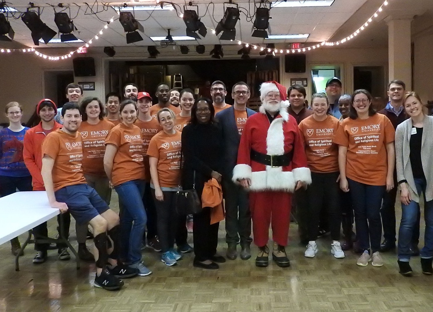 Large group of emory religious life staff in matching orange office shirts