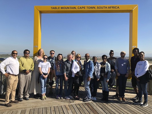 A group in front of a sign for Table Mountain, Cape Town, South Africa